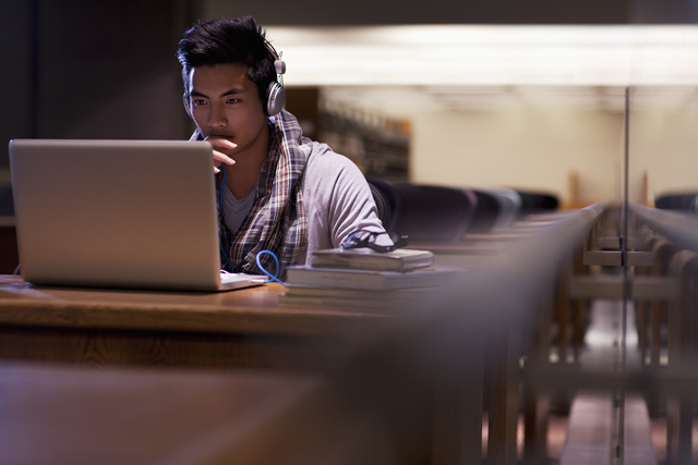 Student Using Computer Wearing Headphones